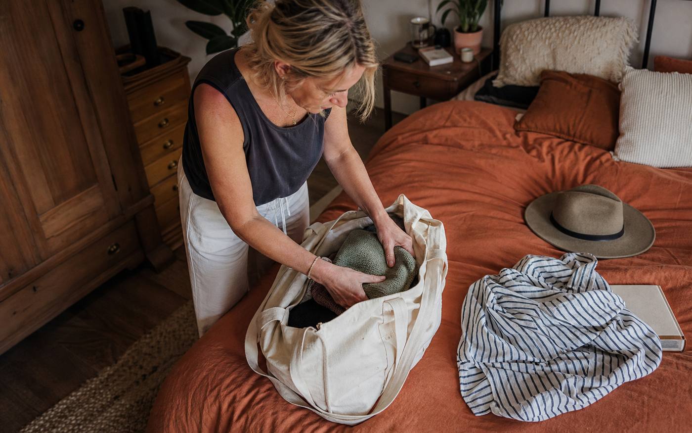 Mulher a preparar uma mala para uma viagem curta